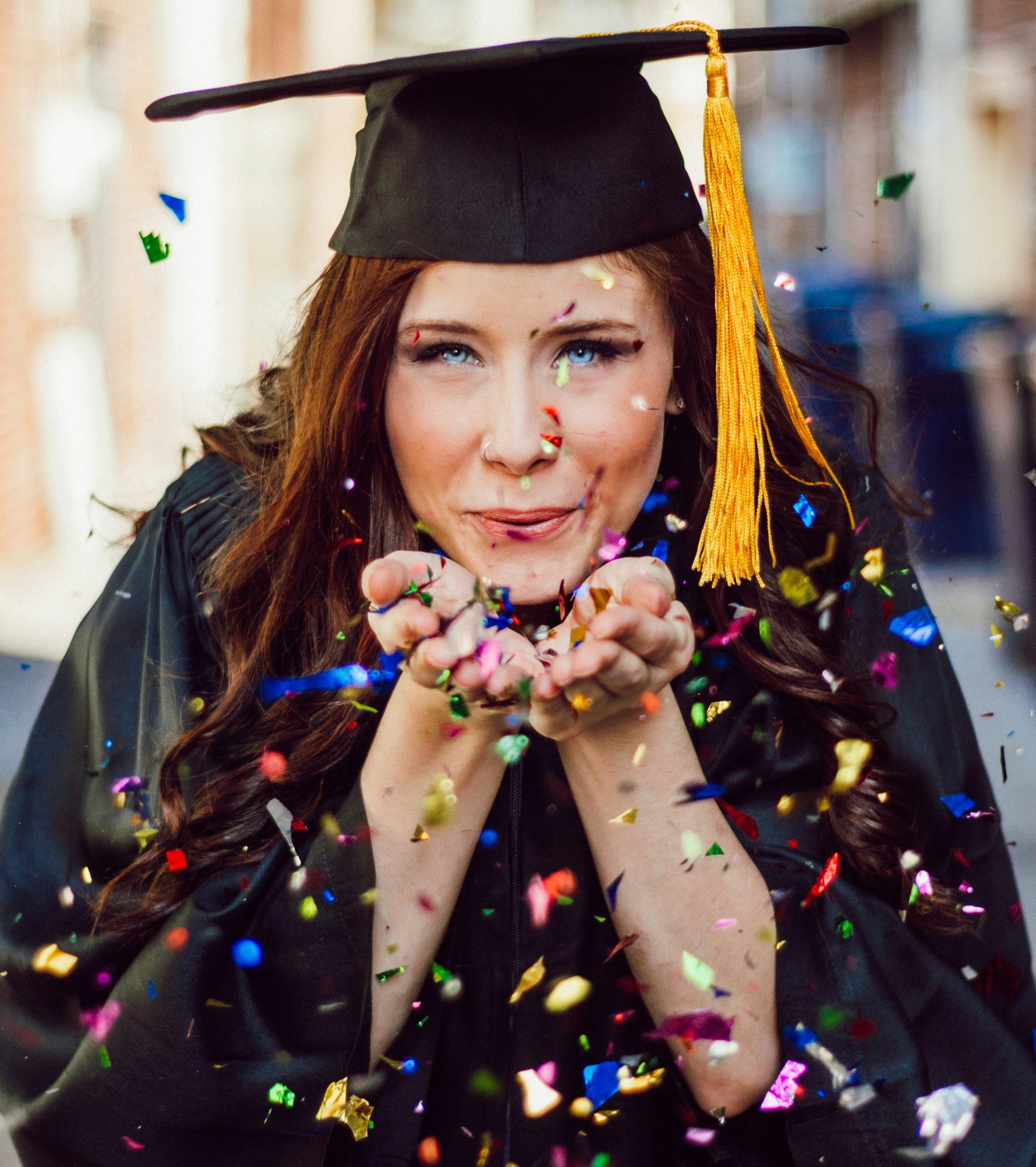 High School Senior Graduate Blowing Confetti